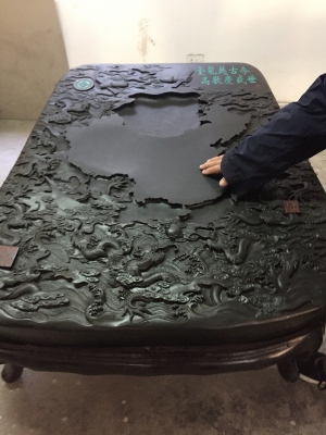 Ink sticks are ground on an ink stone with water until the water turns as black as you like. Most are no larger than your palm. This is a very large ink stone that has been intricately carved. The center flat area is where you grind. It slopes slightly into a well to collect the ink.